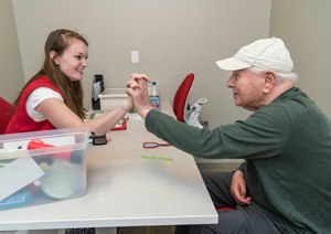 Student working with patient at stroke clinic