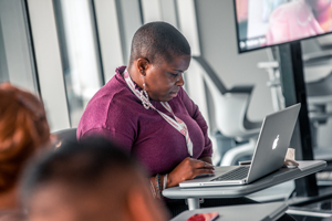 Woman using laptop in classroom