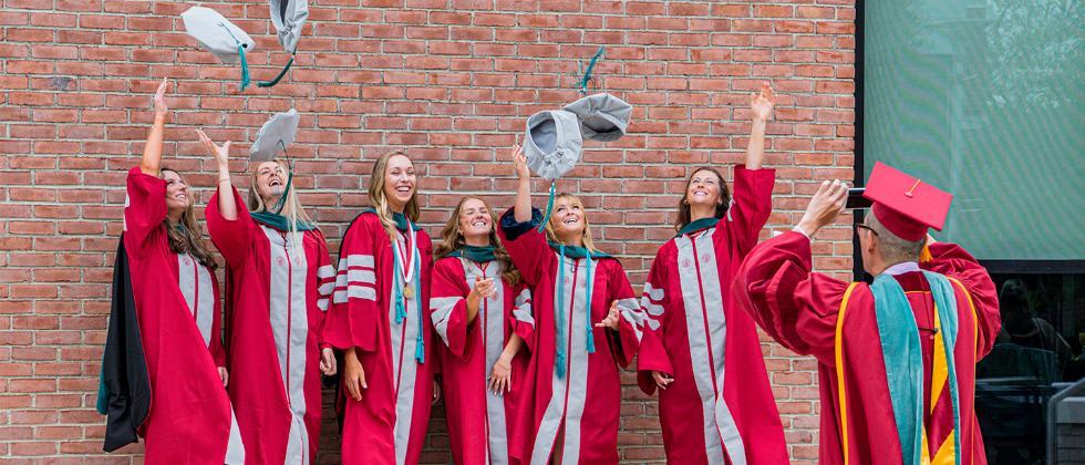 Graduates throwing their caps
