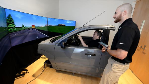 person in a driving simulator