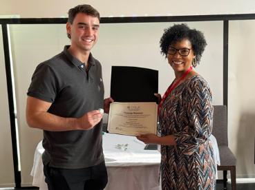 Student receiving certificate from staff member