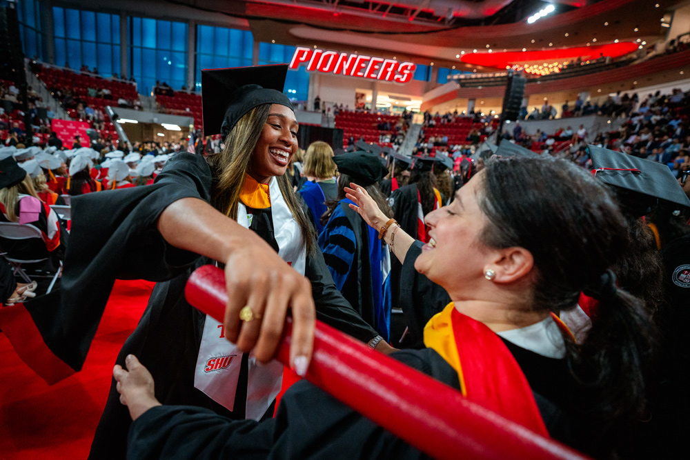 Graduate hugging professor at Commencement