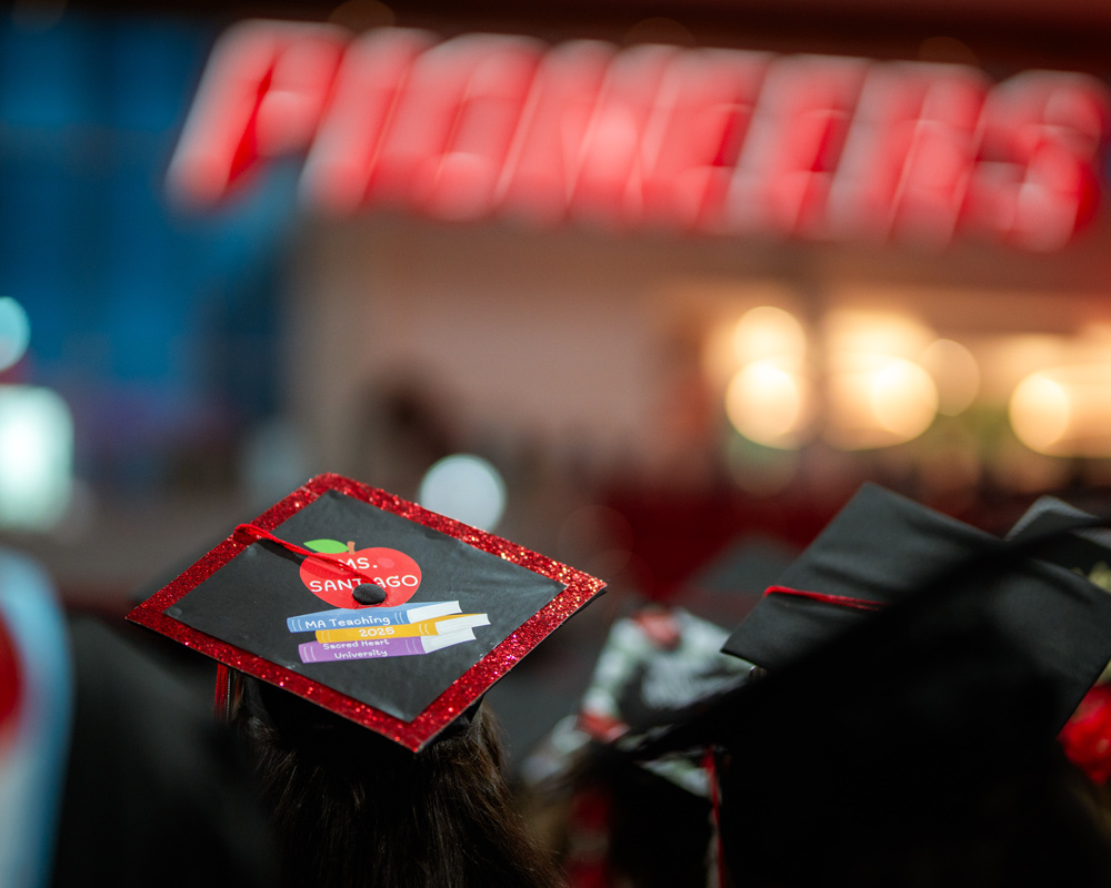 Graduation cap that says Ms. Santiago | MA Teaching, 2025, Sacred Heart University