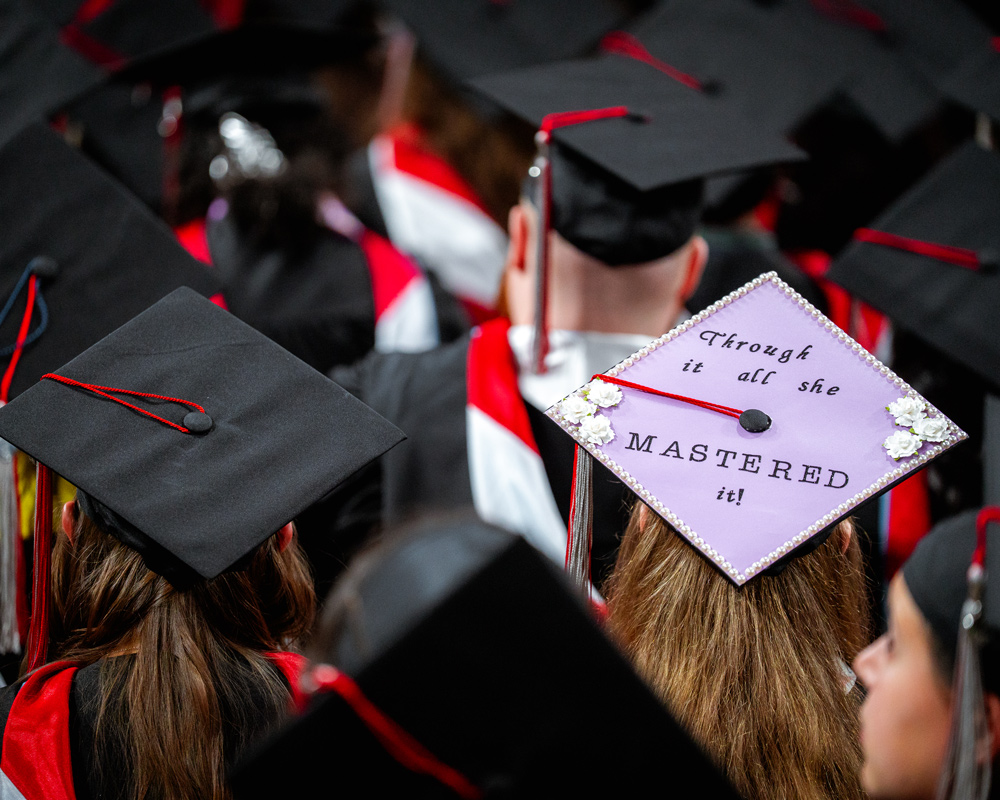 Graduation cap that says Through it all she mastered it