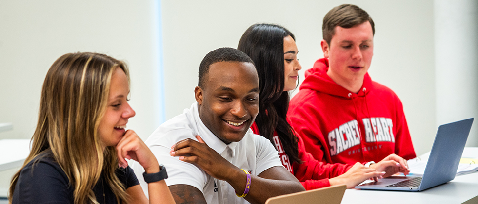 four college students in a classroom