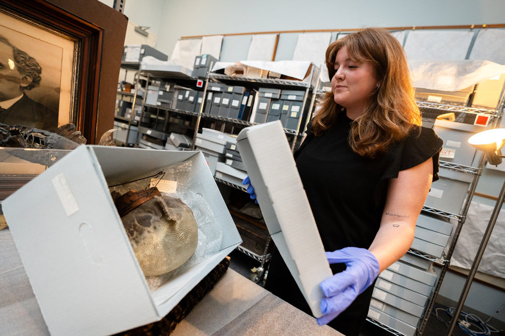 Eliza Lyons opening box with artifact inside