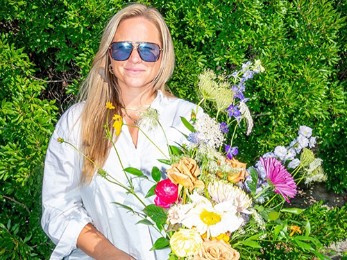 Chelsea VanDerheyden Olayos holding a bouquet of flowers