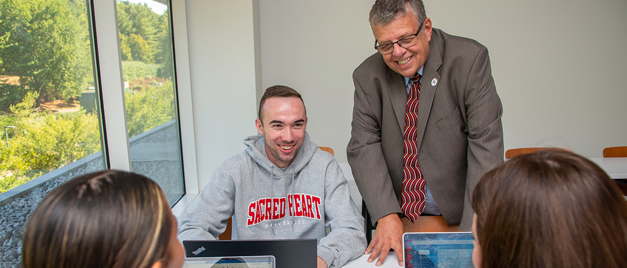 Professor working with three students