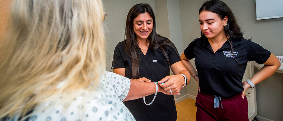 two occupational therapists working with a client
