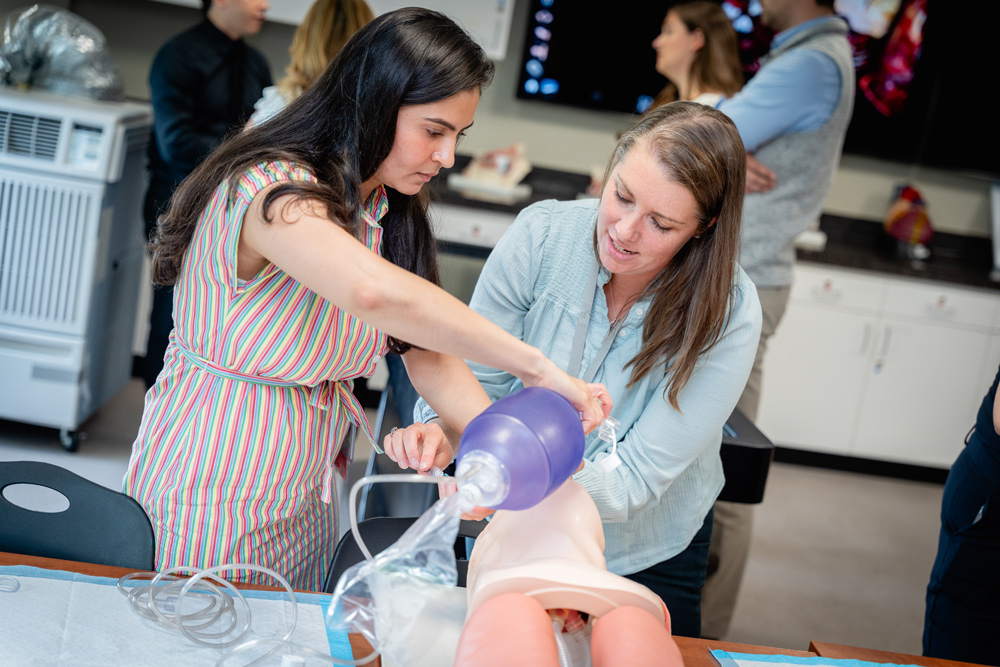 Professor showing student how to use a Bag-Valve-Mask