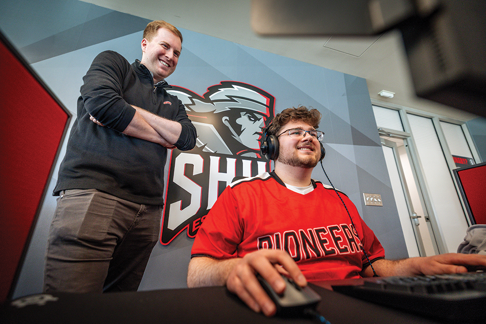Professor watching student play video game
