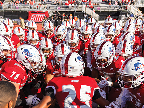 SHU Football team in a huddle