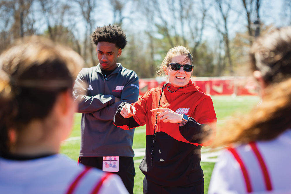 Kate Dubois talking to the team on the field