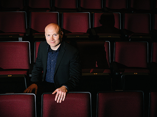 Matt Oestreicher sitting the theater seats