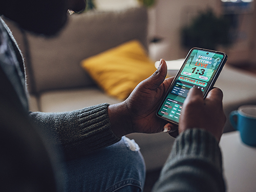 Person betting on sports on their phone