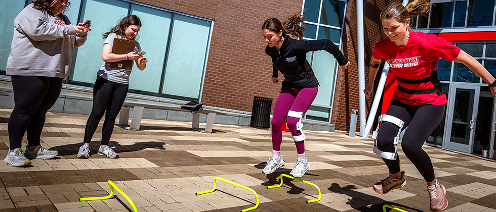 students conducting physical jumping tests in a physical therapy class