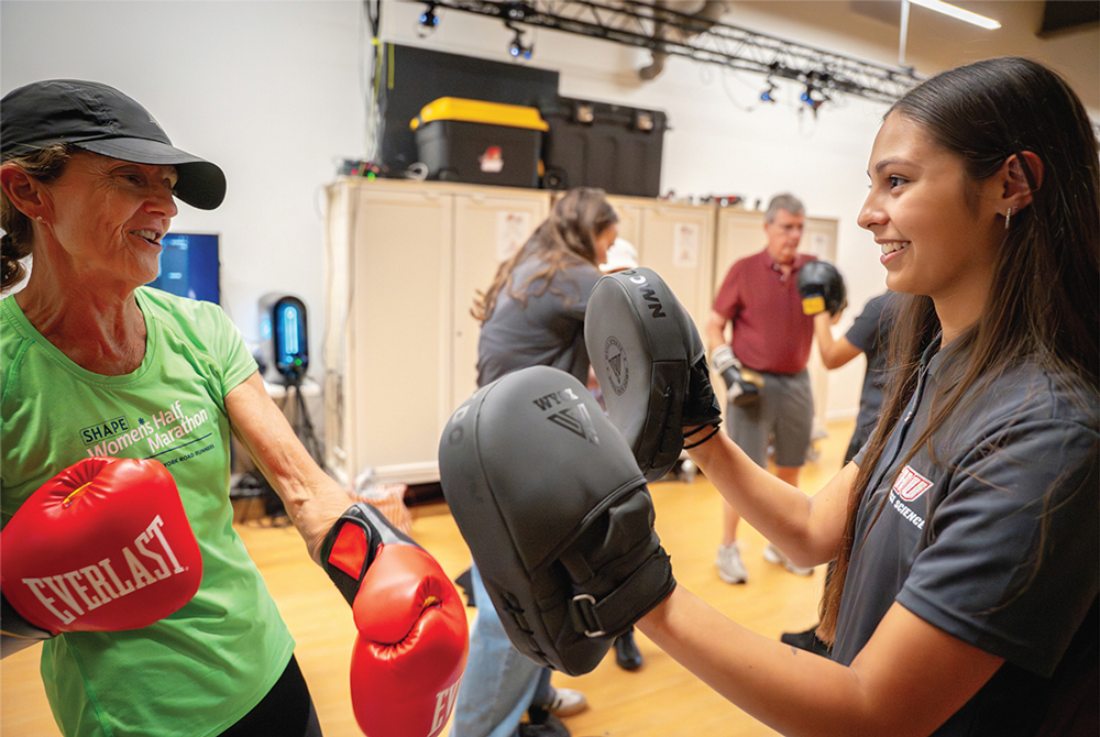 Student helping patient box
