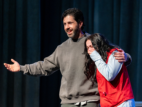 Josh Peck onstage with a shy Sacred Heart University student