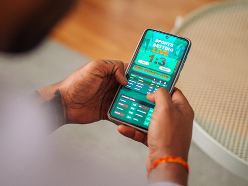 Person placing a bet on their cell phone