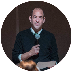 Andrew Miller talking on a microphone
