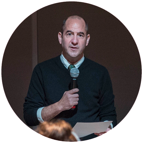 Andrew Miller talking on a microphone