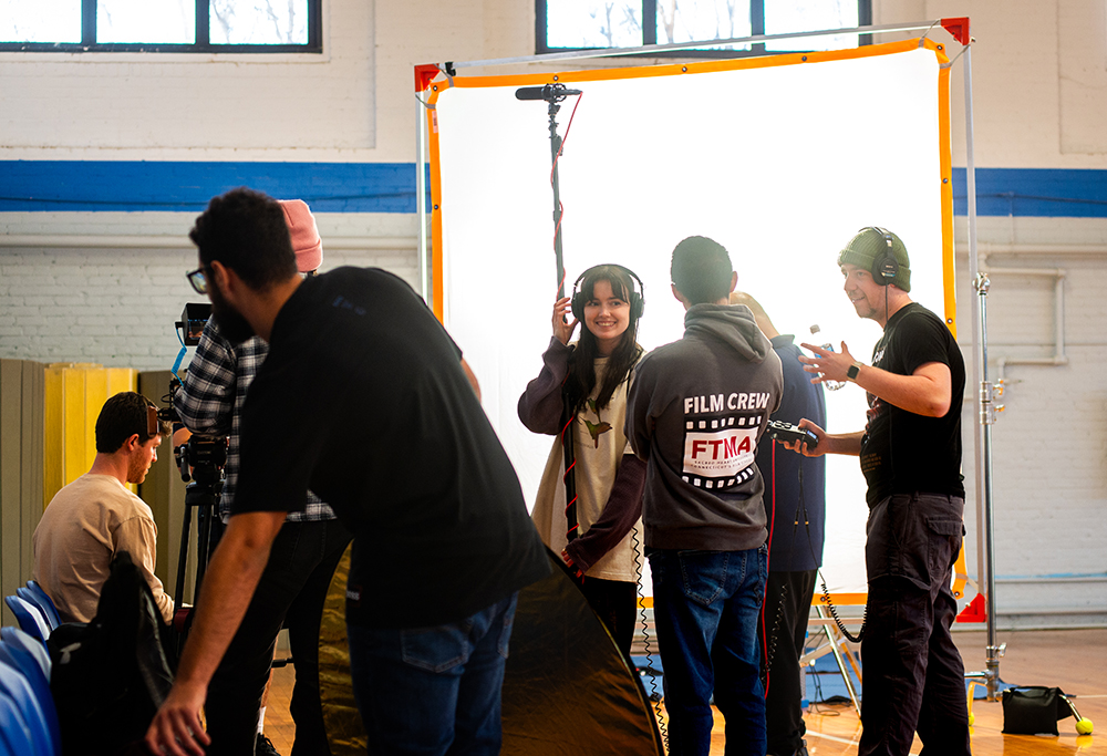 people on a movie set setting up lighting