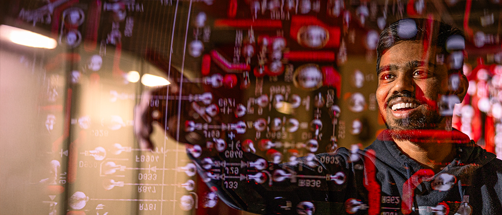 Student pointing at superimposed computer code over image