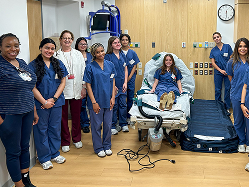 Students in program posing for photo in nursing lab