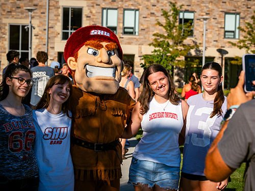 Students taking a photo with Big Red