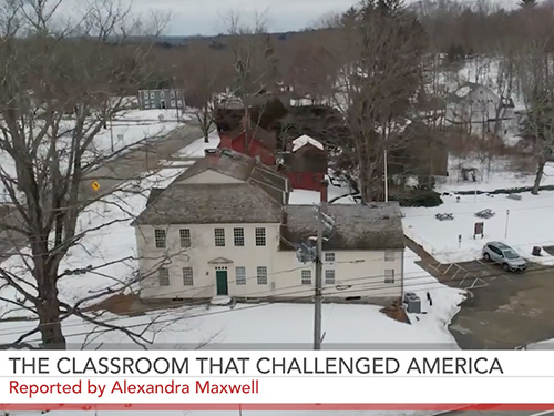 Screenshot from reporting video of an aerial view of a snow covered town