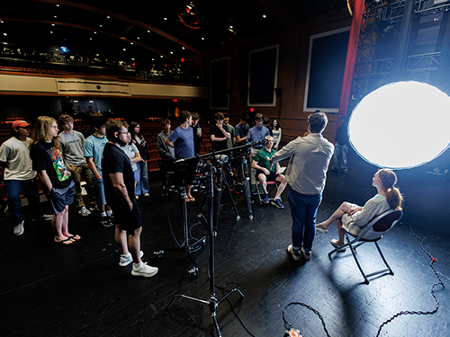 Students on stage learning how to make a movie