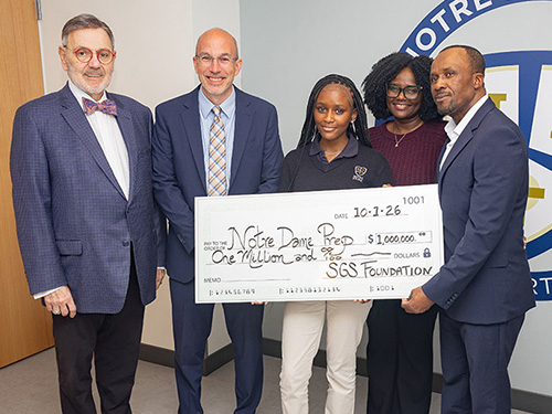 People holding large donation check