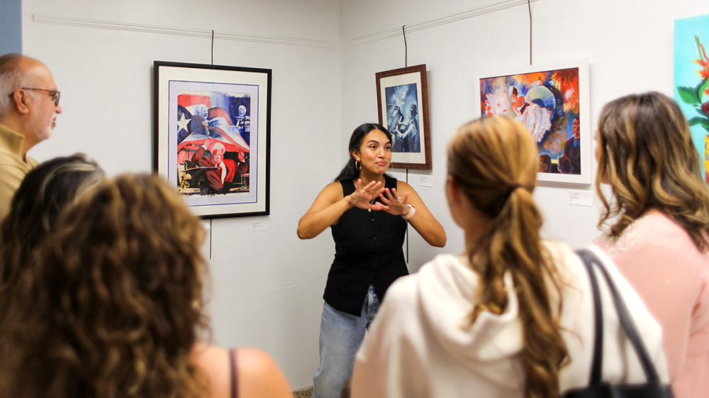 Corinne Baptiste speaking to viewers about her art