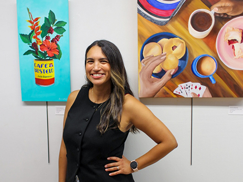 Corinne Baptiste posing with her art