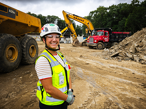 Woman in construction safety gear at a construction site
