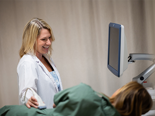 Courtney Yeager taking a sonogram on patient