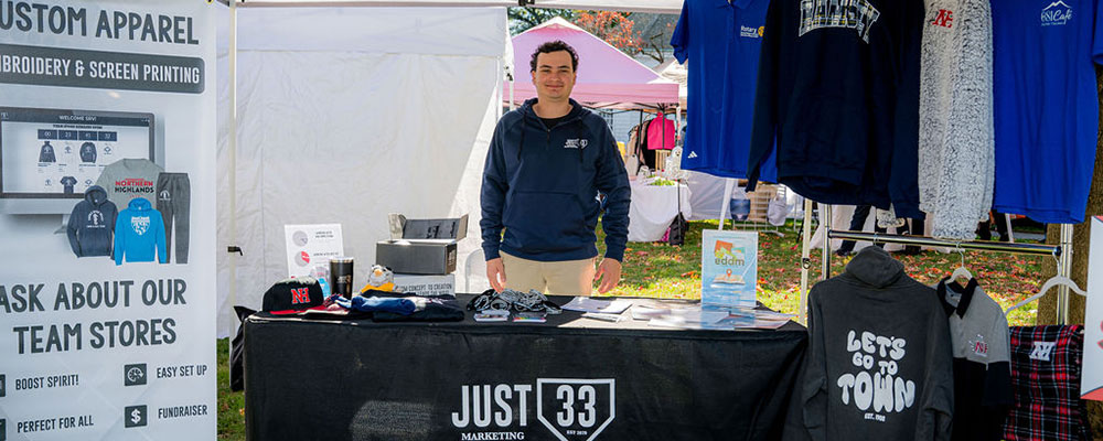 Sheldon Wright standing at a marketing booth for his company