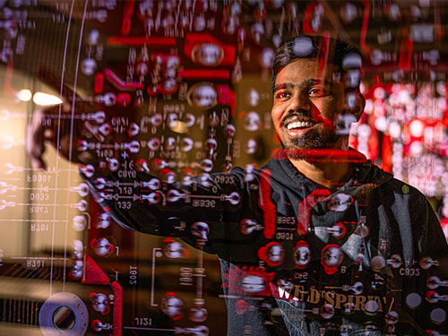 Student pointing to code superimposed over image