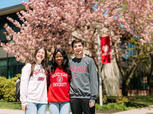 Three students smiling