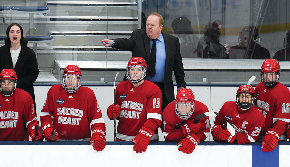 Coach Tom OMalley instructing his players during a hockey game