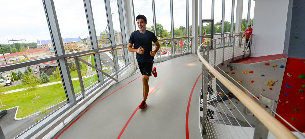 Student running on track inside facility
