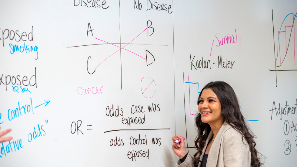Student writing on white board