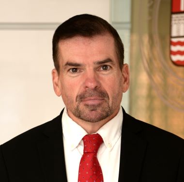 Gary MacNamara wearing a suit and tie.
