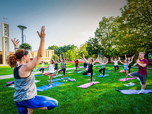 people participating in an outdoor yoga class