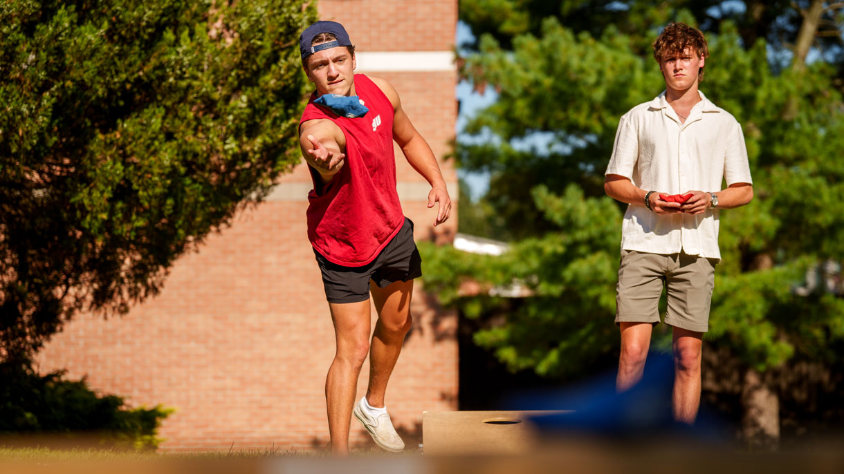 Students playing cornhole