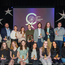 Students with awards on stage