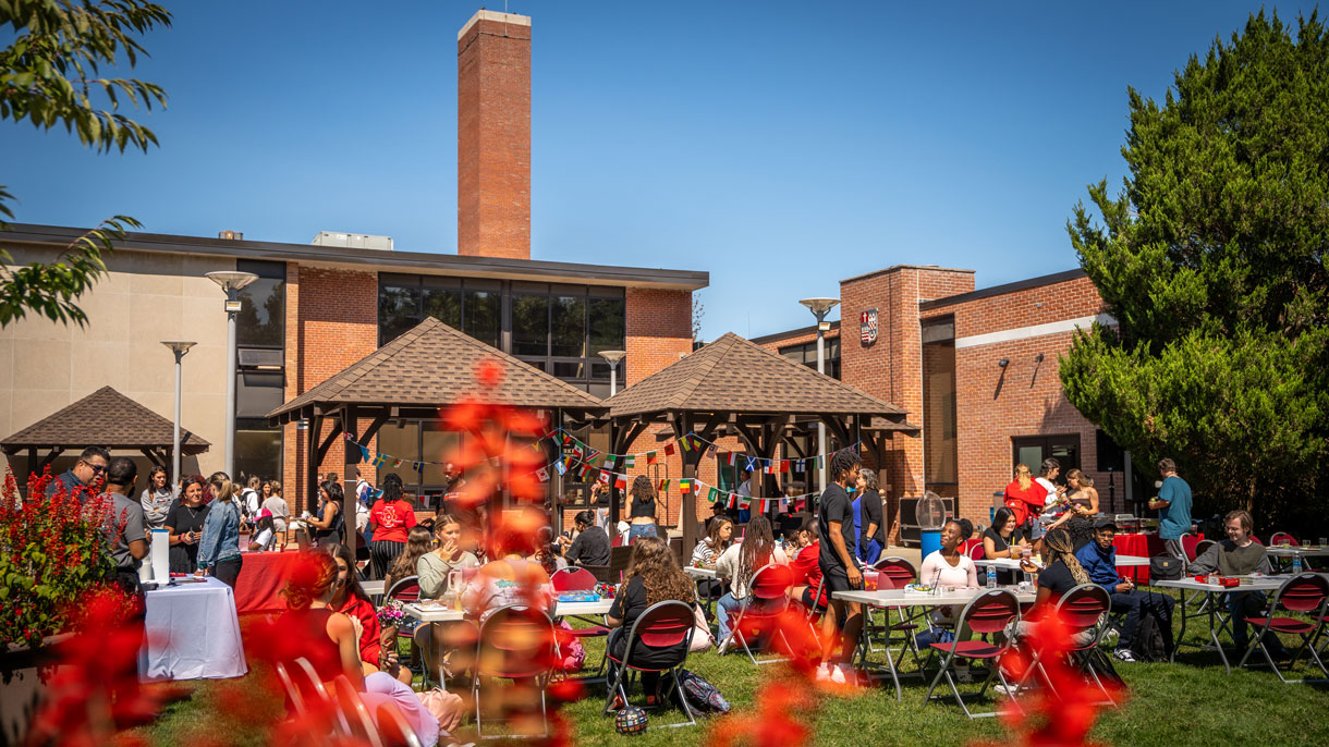 Students sitting outside at a cookout
