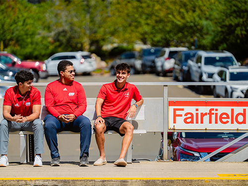 three people waiting for a train at the Fairfield train station