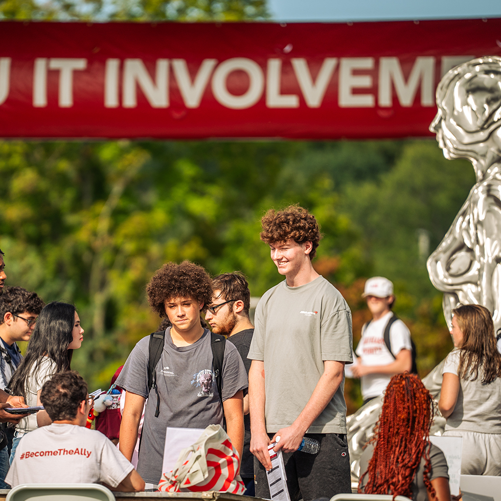 Students visiting an information table at a college involvement fair