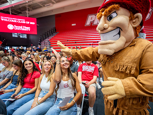 Big Red the Pioneer giving a student a high five